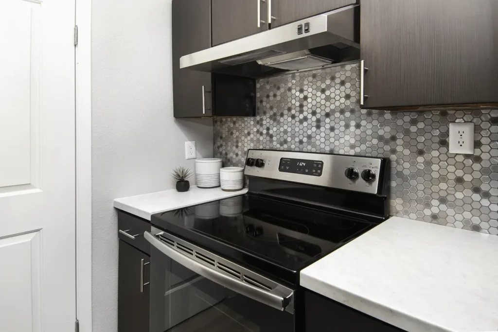 Kitchen with white counters and stainless steel appliances