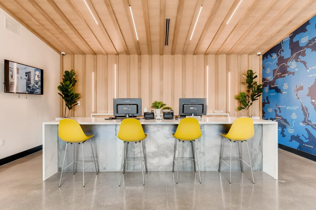 Leasing office reception desk with computer stations and chairs