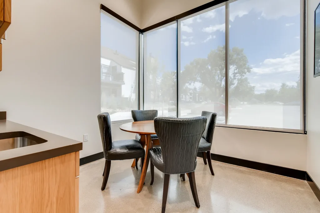 Dining table next to large windows