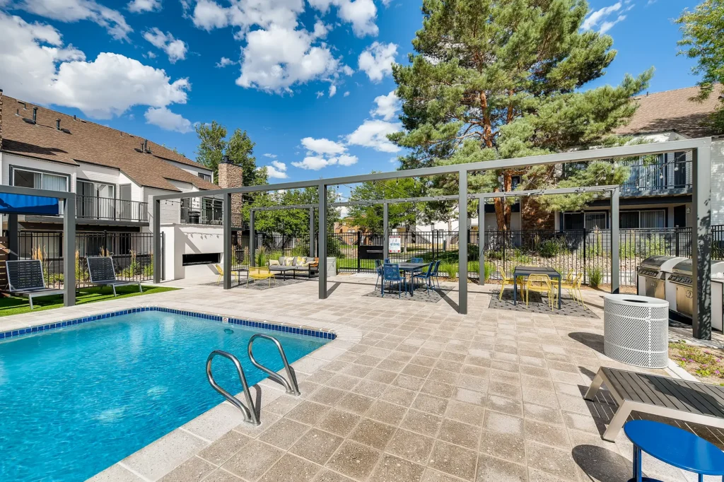 Pool with deck seating at Park at Canyon Ridge apartment complex in Aurora, CO