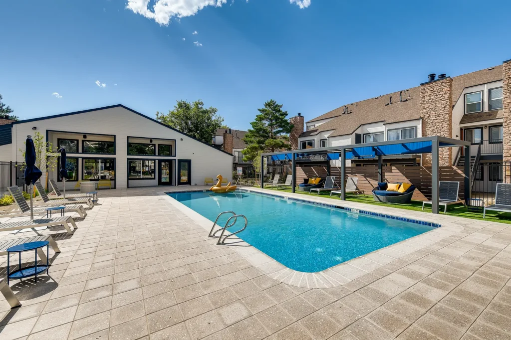 Pool with deck seating and shaded cabanas