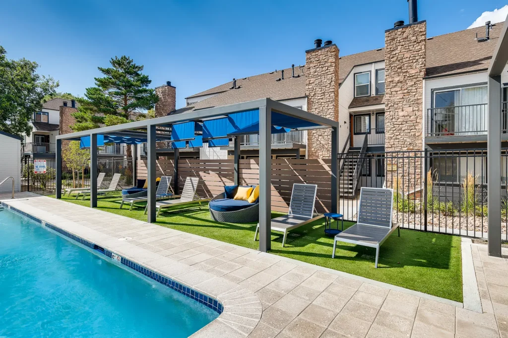 Pool with deck seating and shaded cabanas