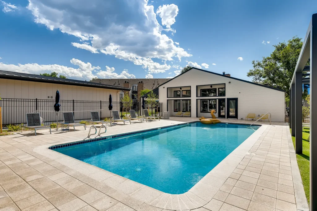 Pool with deck seating and shaded cabanas